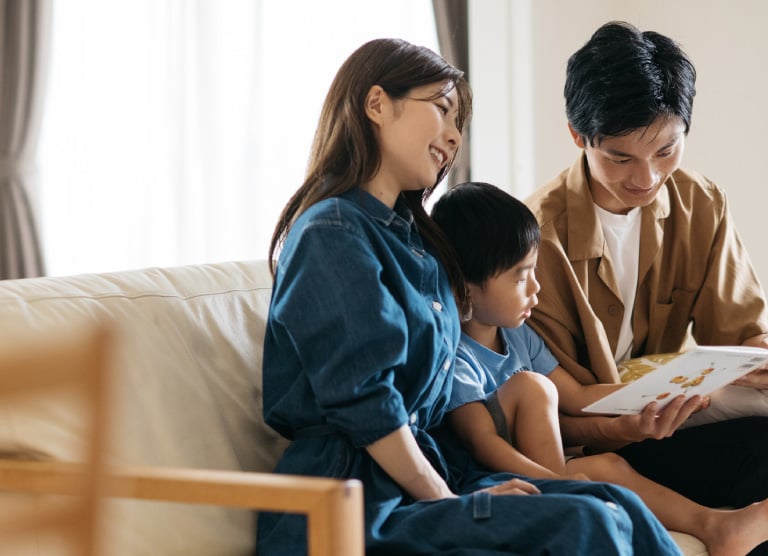 リビングで本を読む家族